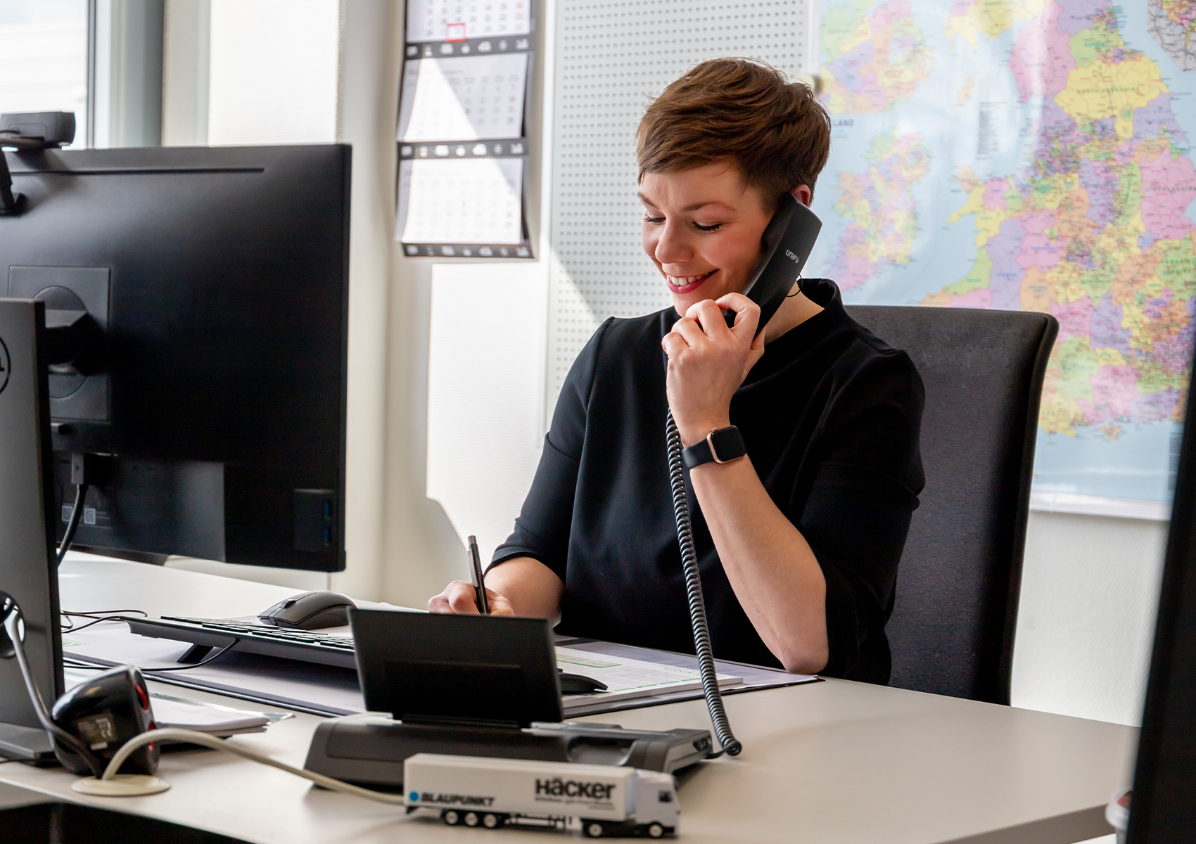 Lady on the phone in front of a desk
