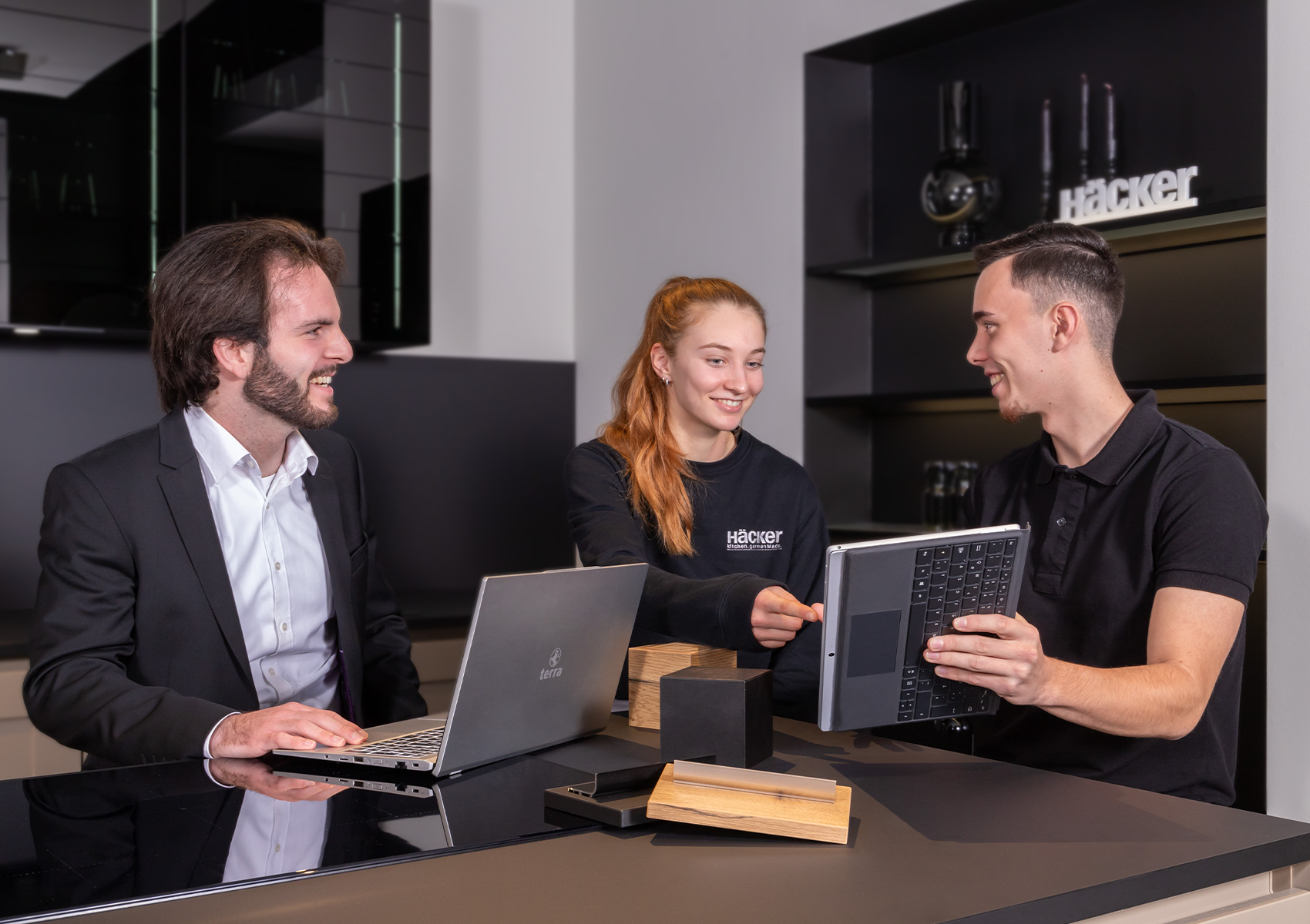 Hacker staff members in a showroom